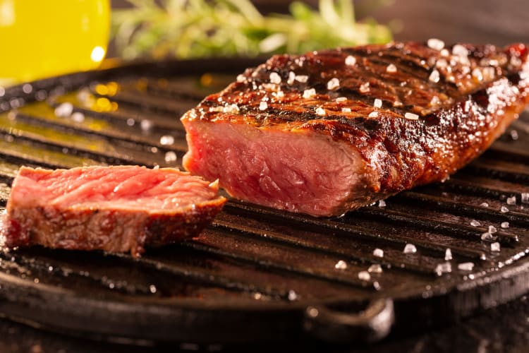 Picanha on a skillet topped with sea salt