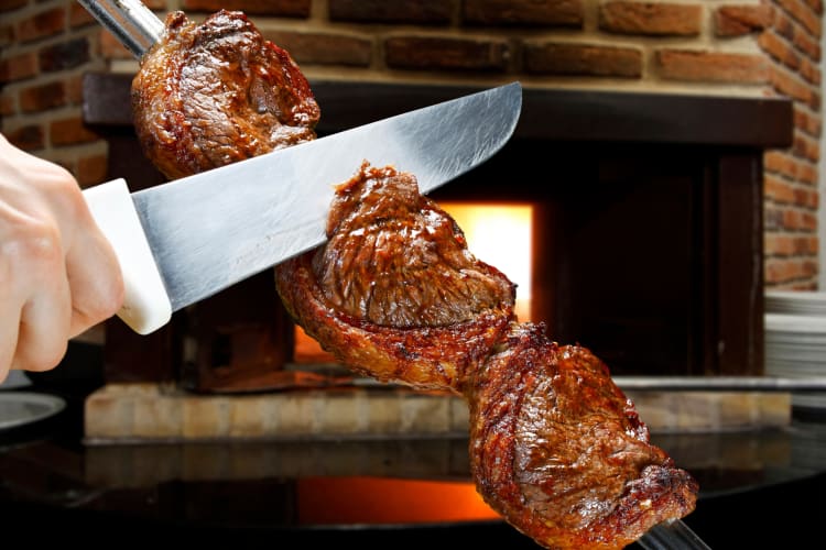 Brazilian picanha being cut