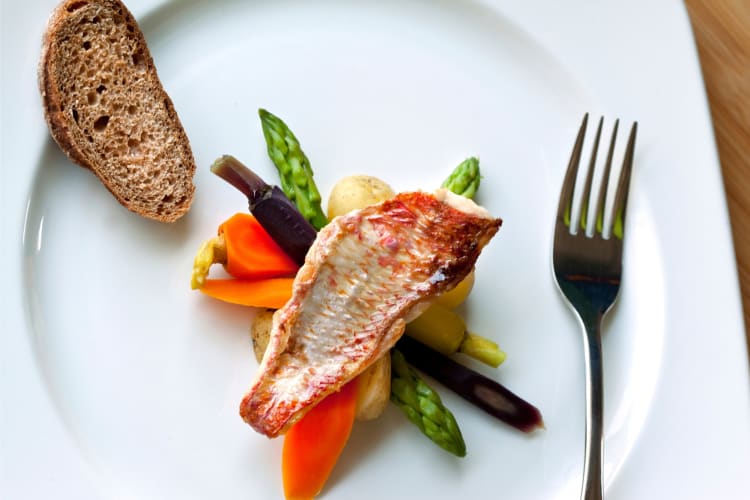 A red mullet fillet served with vegetables