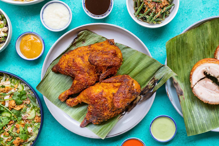 Aerial view of chicken inasal and sauces, from Lasita, a restaurant in Chinatown, Los Angeles