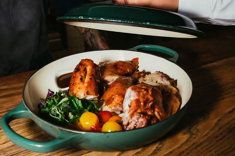 Half-roasted chicken served with potatoes and salad