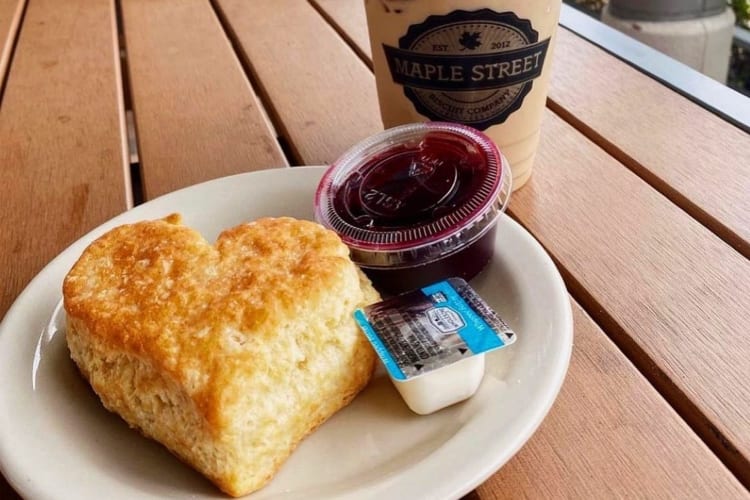 A heart-shaped biscuit next to an iced coffee