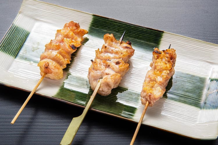 A plate of three skewers from Yakitori Torishin in NYC