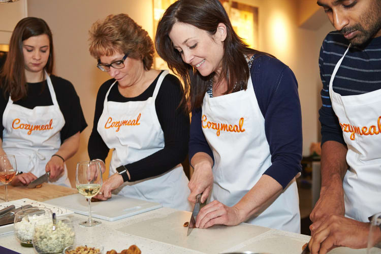 Four people taking a cooking class booked through Cozymeal