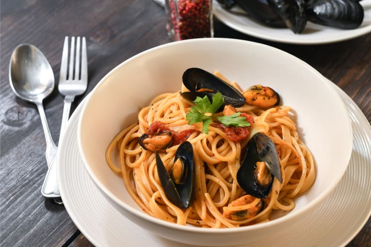 Seafood pasta served on a white plate
