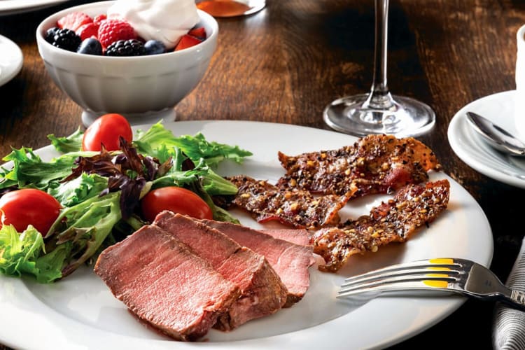 A meal with grilled meats and salad from Fogo de Chão