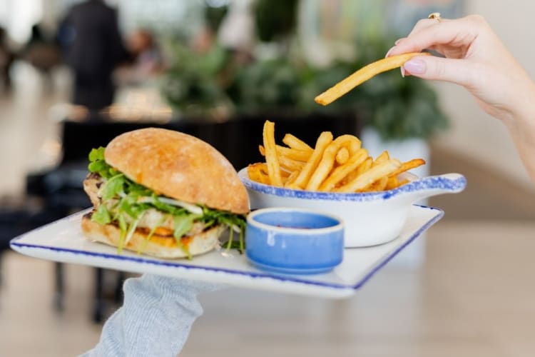 Lemon and rosemary grilled chicken sandwich served with fries