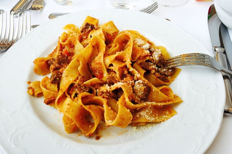 Pappardelle al ragù topped with Parmesan