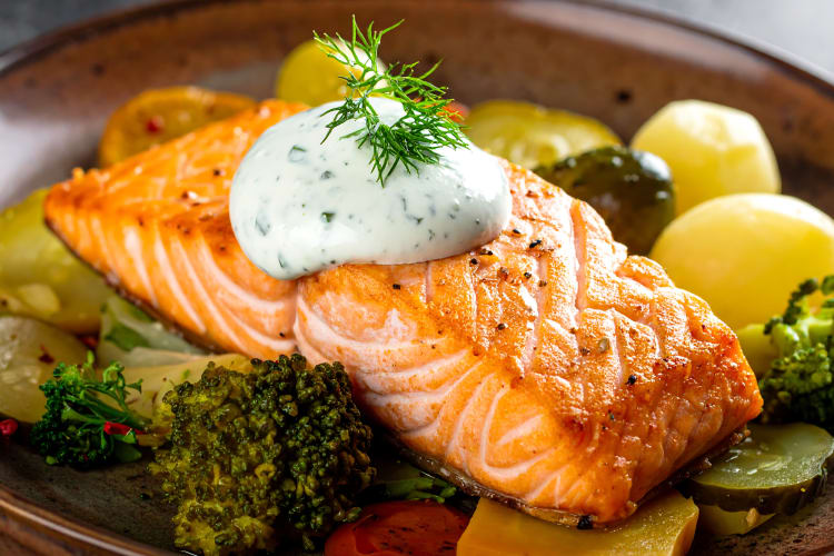 salmon on a bowl of vegetables
