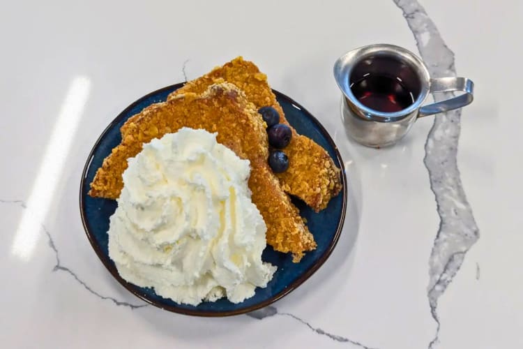 Cider bread with a cereal crust, maple syrup, orange-rosemary whipped cream and Fruity Pebbles or Frosted Flakes. 