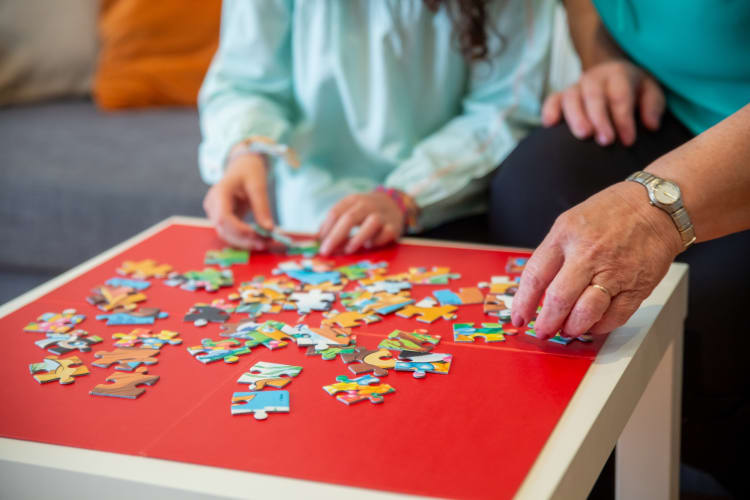 People playing jigsaw puzzle