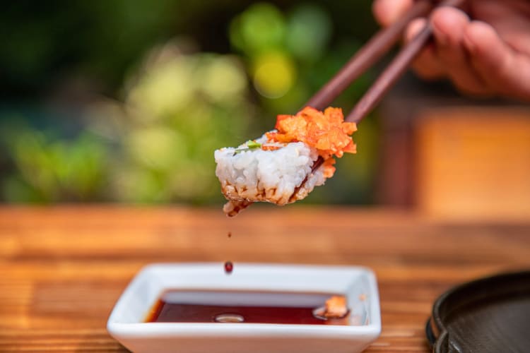 Dipping sushi in soy sauce