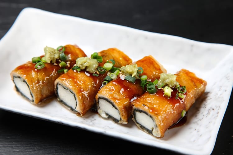 Four pork rolls on a white dish