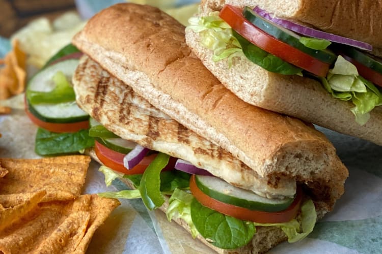 Two Subway subs with grilled chicken and vegetables