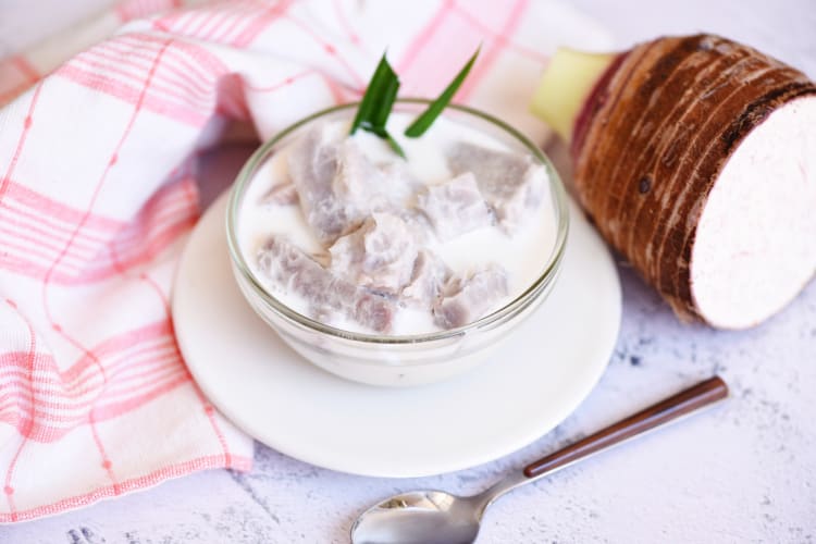 A bowl of taro dessert with sugar and milk