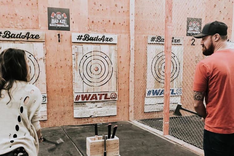 Two people looking at each other while at Bad Axe Throwing