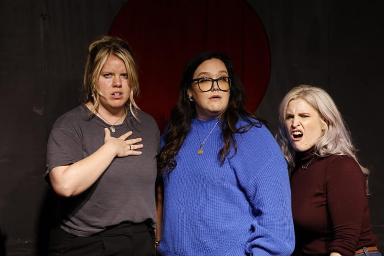 Three women taking an improv class, which is a great team building activity in Dallas