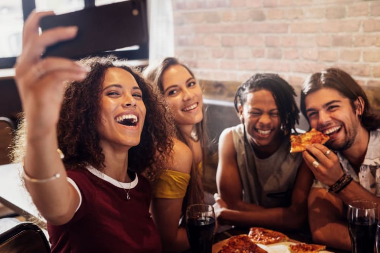 group of people taking a selfie on a restaurant