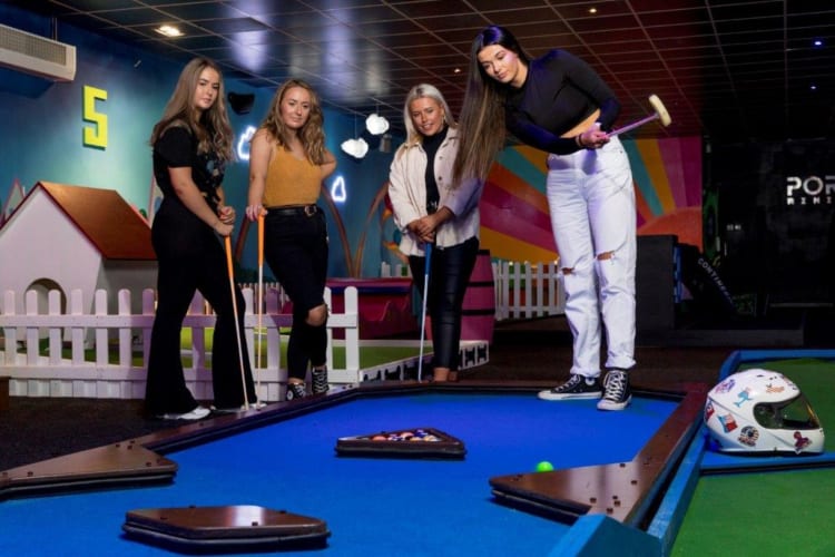 People playing mini golf.