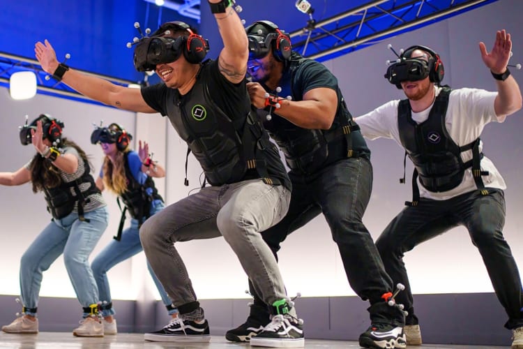 Five people crouching down during a VR experience at Sandbox VR