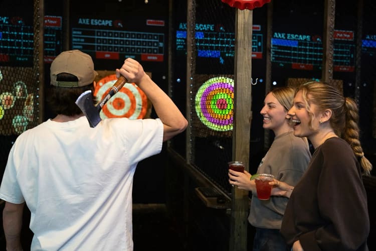 Three people at Axe Escape — a great place to host a team building activity in San Antonio
