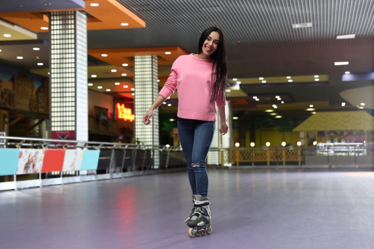 a woman roller skating at a skate rink