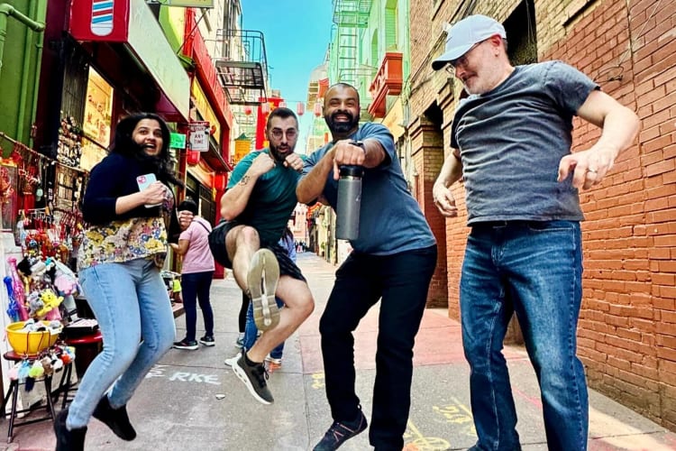 Four people jumping an posing during a scavenger hunt with Watson Adventures