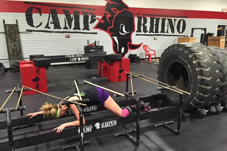A woman doing an obstacle course with Camp Rhino