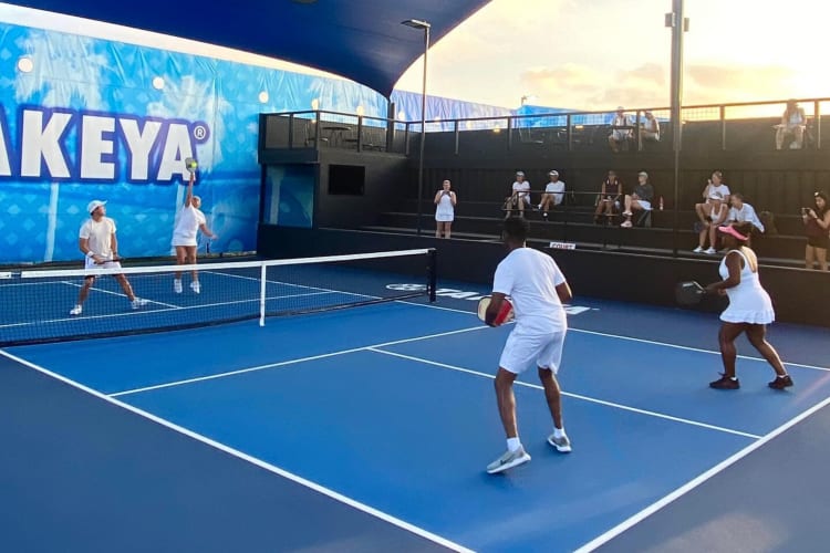 Four people playing pickleball, which is a fun team building activity in San Diego