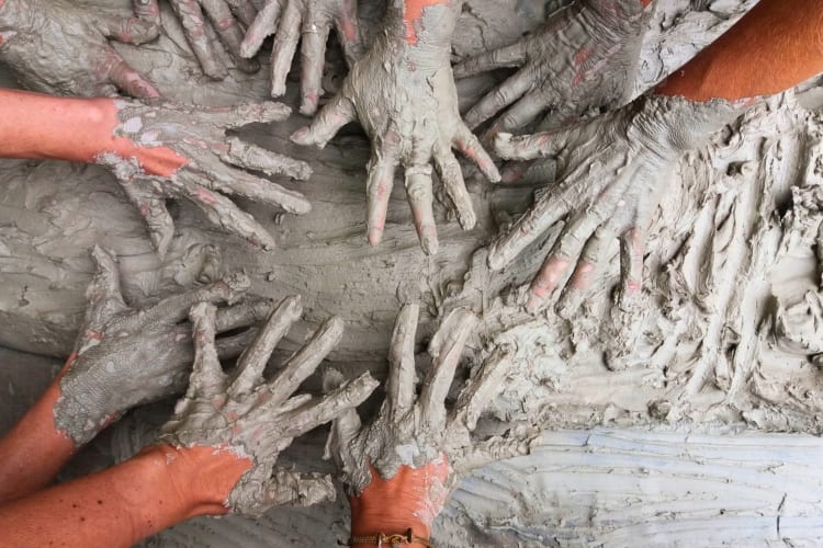Multiple hands with clay