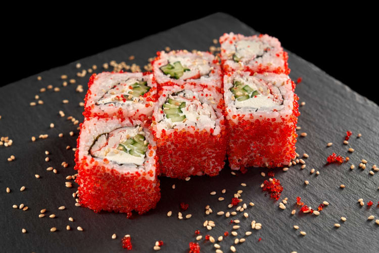 Sushi with red tobiko and sesame seeds