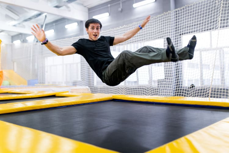 a man jumping on a trampoline