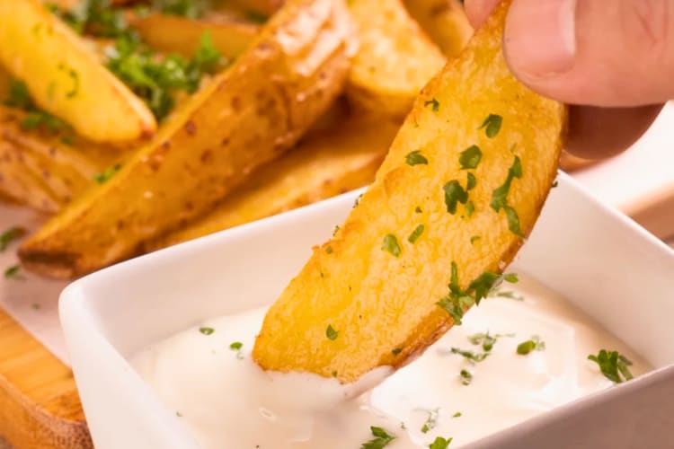 Air fryer potato wedges with a dip.