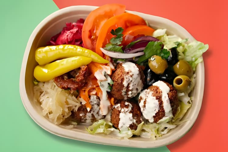 Falafel bowl served with veggies and hummus