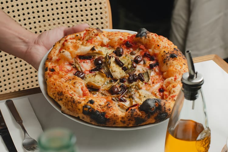 Tomato base pizza with Mozzella, grilled artichokes, olives, wild mushrooms and smoked beetroot