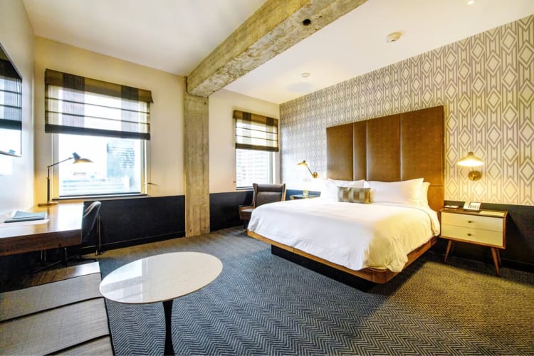 a bright, richly appointed hotel room with large bed  