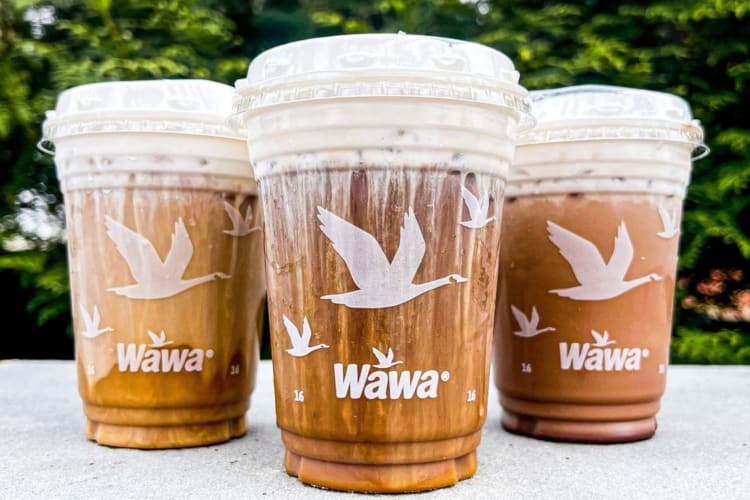 Three Wawa machiatos served on to-go cups