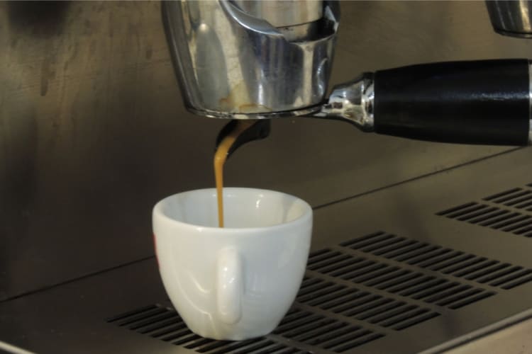 An espresso being pulled from a coffee machine