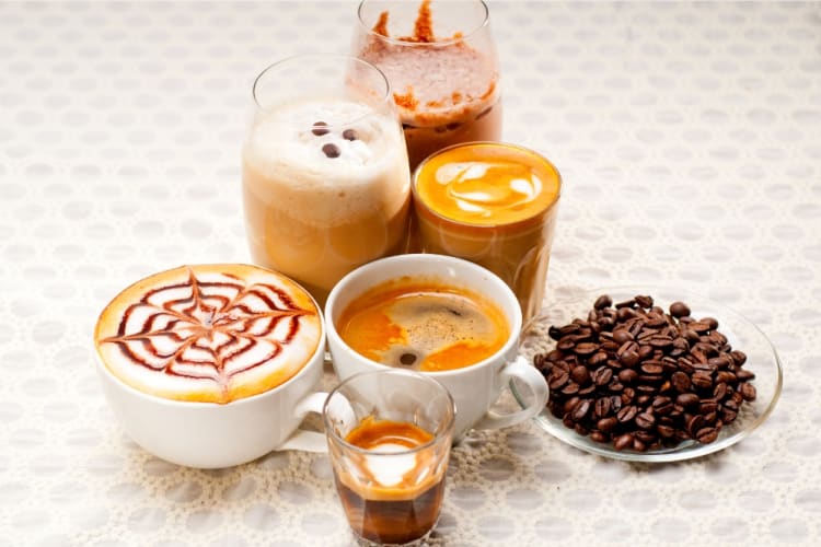 Six different coffee types next to coffee beans