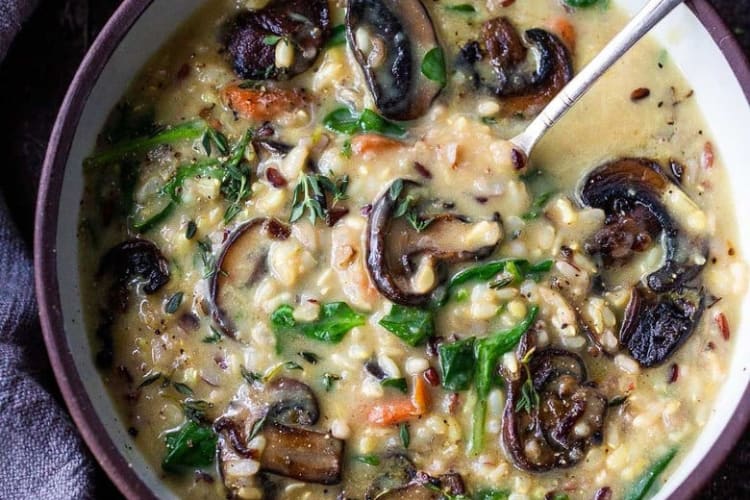 instant pot wild rice soup with spinach and mushrooms are a vegetarian take on a classic soup