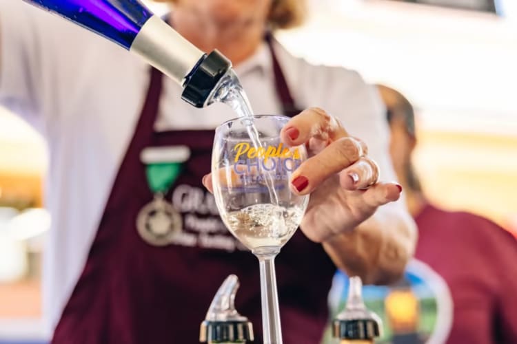 Pouring a glass of wine at GrapeFest