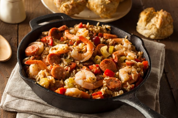 Jambalaya is shown in a black skillet on a table