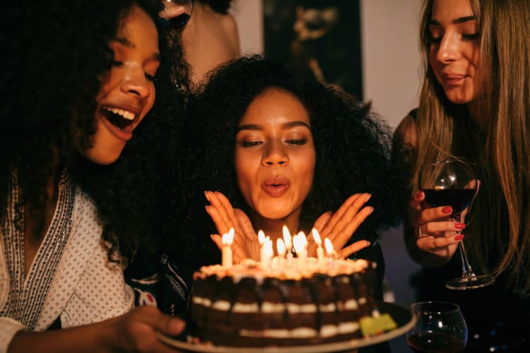 Woman blowing birthday Cake