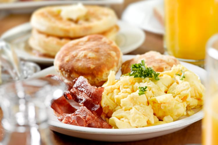 Eggs, bacon and biscuit in a ceramic plate