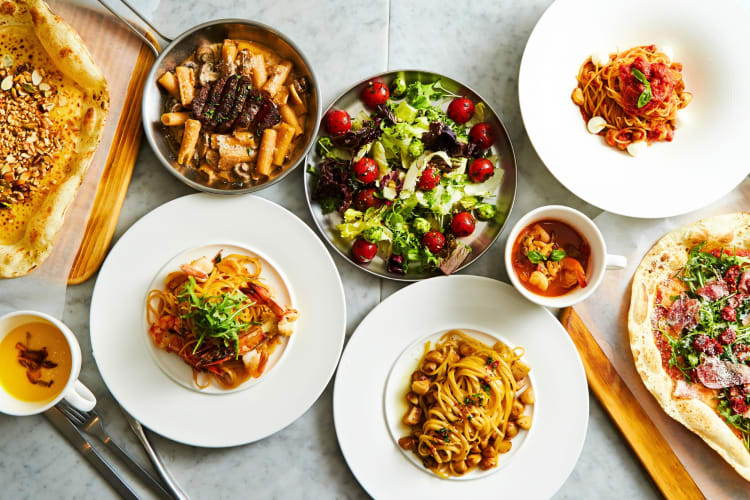 People digging in their restaurant food plates