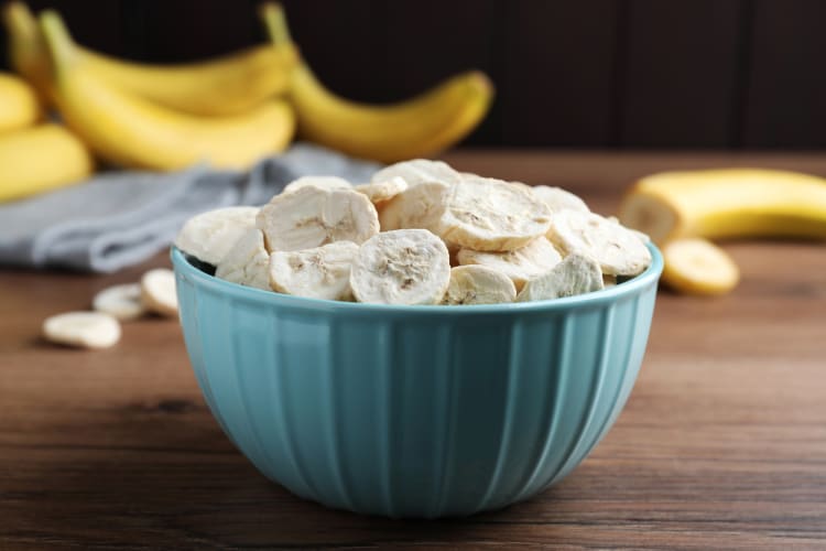 Frozen bananas on wooden table