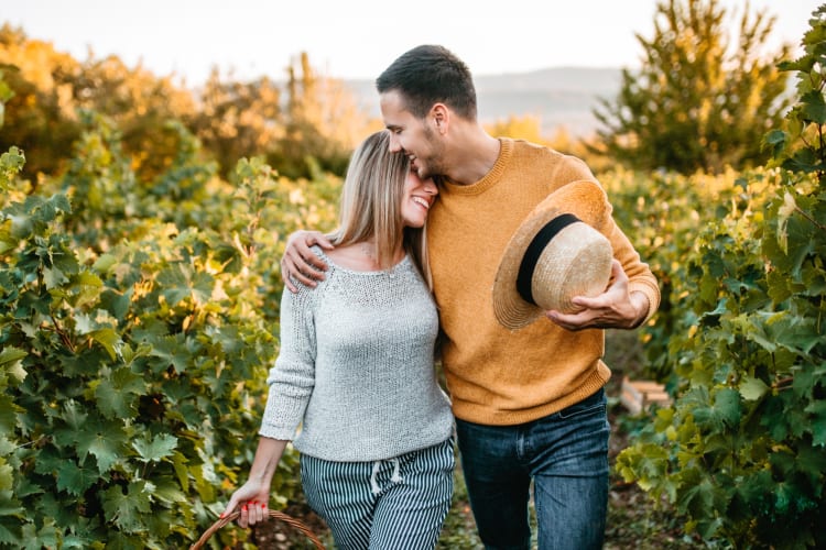 A couple hugging in a vineyard