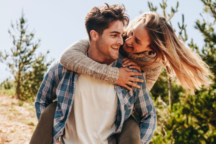 Couple hugs on street. Men hugging woman. Urban couple date. Happy