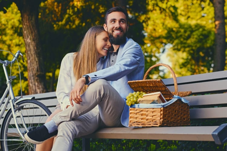 couple laughing on a park bench