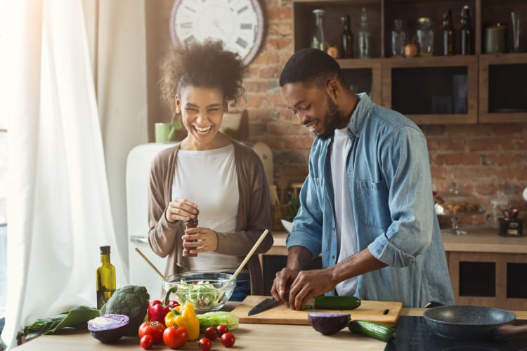 two people cooking